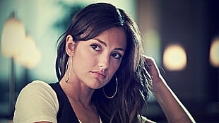 woman wearing black and white shirt with silver-colored hoop earrings