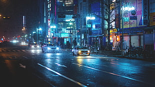 white car on gray asphalt during nighttime