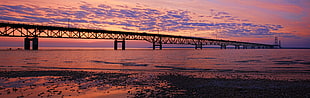 gray metal bridge during sunset