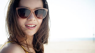 closeup photo of woman wearing brown-framed sunglasses