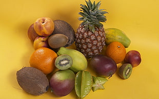 assorted fruits on yellow surface