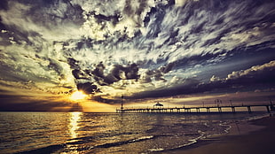 body of water under blue and white cloudy sky during sunset