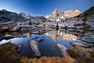 rocky mountain ranges near a body of water during daytume HD wallpaper