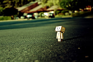brown box head toy in the road watching something wallpaper HD wallpaper