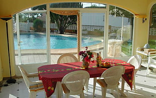 table near the door and swimming pool HD wallpaper