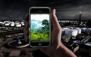 person holding black iPhone 5 capturing cityscape