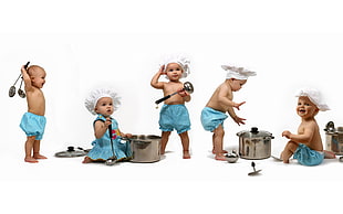 baby wearing white toque while holding kitchen utensils on white surface
