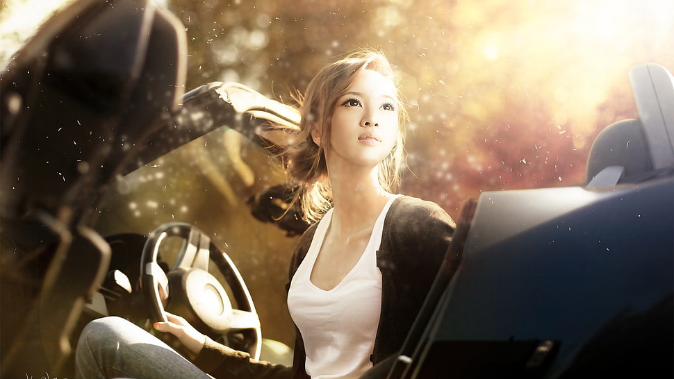 woman wears white tank top sitting inside car HD wallpaper