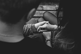 grayscale photography of man and woman holding hands