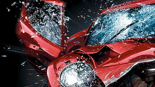wrecked red vehicle with cracked windshield