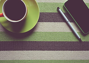 white twist pen beside green smartphone on top striped textile HD wallpaper