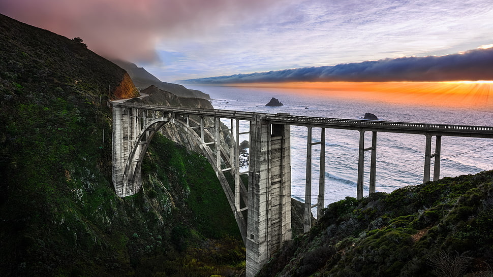 gray concrete bridge near body of water during daytime HD wallpaper