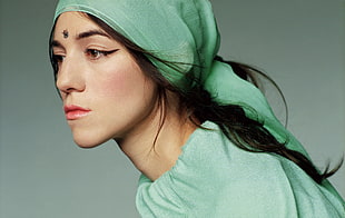 photography of black haired woman wearing green turban