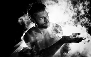 grayscale photo of man with smoke