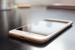 silver iPhone 6 on black surface