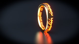 standing gold-colored carved ring photography