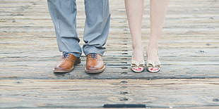 standing man in gray pants and standing woman in silver peep-toe heels HD wallpaper