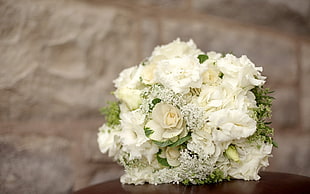 white petal bocquet flower on wooden table