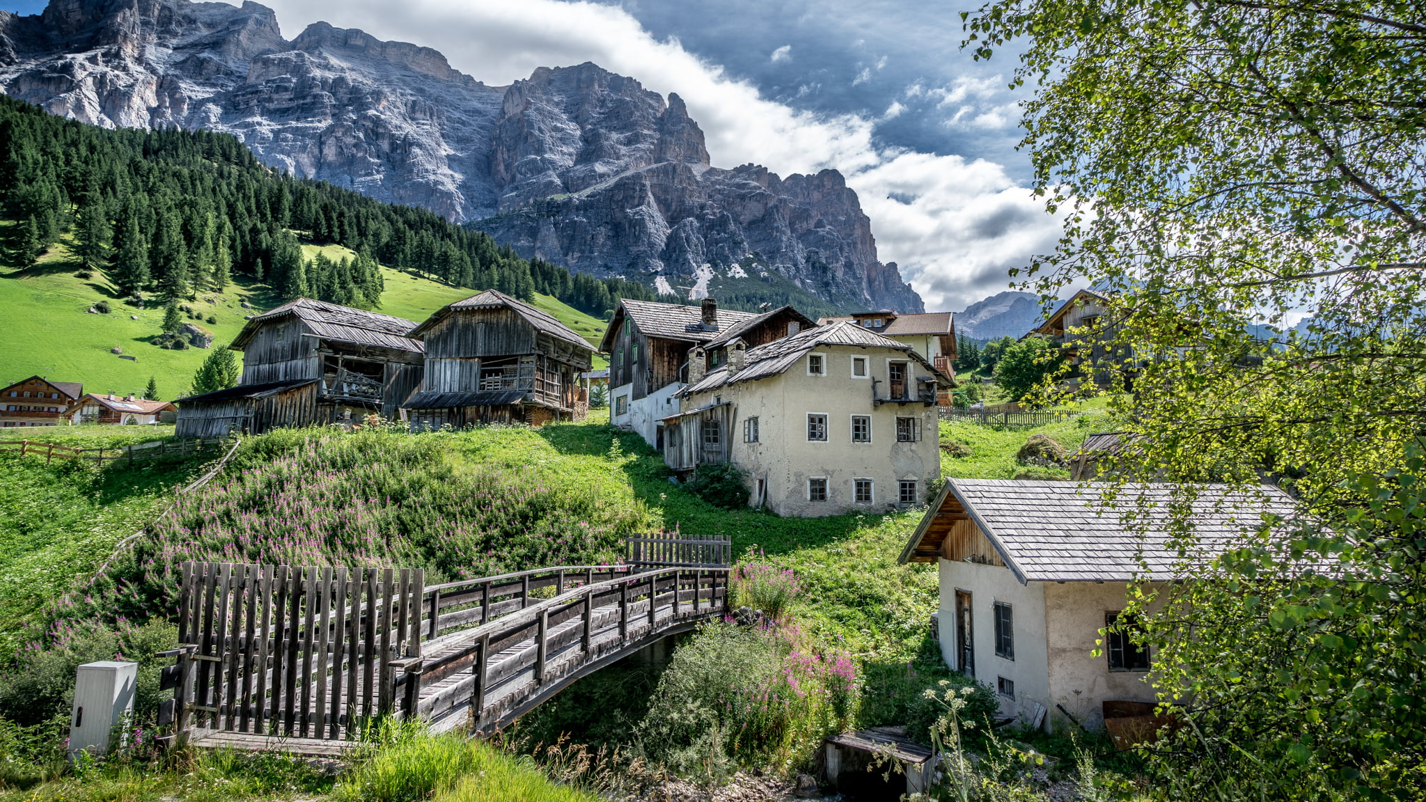 woooden bridge closed across houses, san cassiano, alta badia, italy