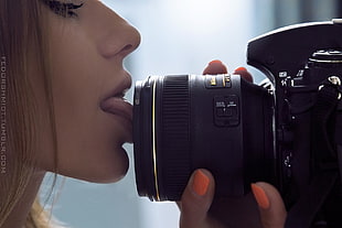 black DSLR camera, women, long hair, camera, licking