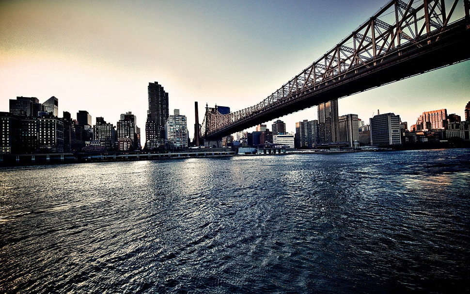 black metal bridge across the river during daytime HD wallpaper