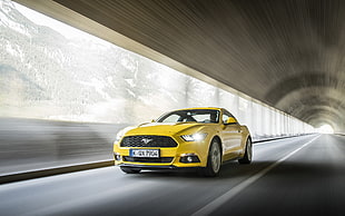 time lapse photography of yellow Ford Mustang coupe on road