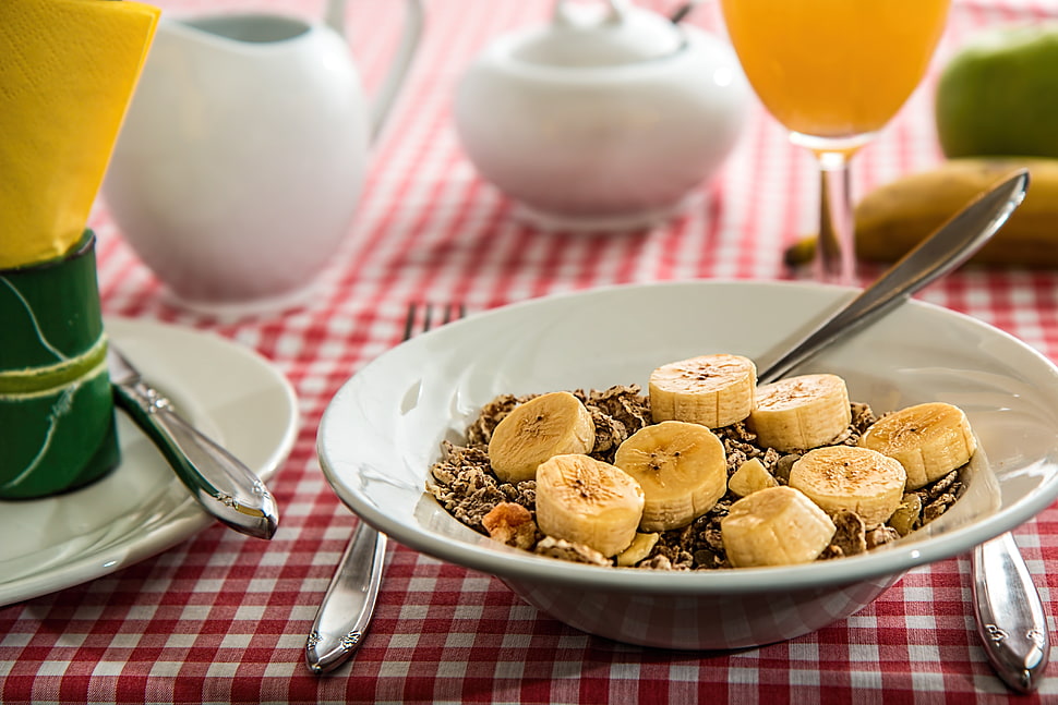 sliced bananas and flakes on white ceramic plate HD wallpaper