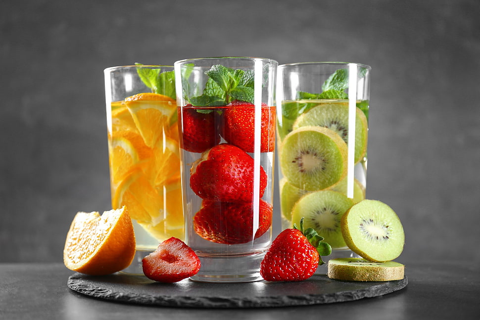 three kiwifruit, strawberry, and orange water therapies, food, drinking glass, fruit, kiwi (fruit) HD wallpaper