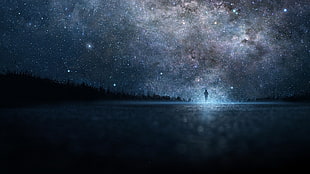 person walking under starry night
