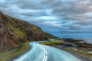 landscape photography of road near mountain and body of water, iceland