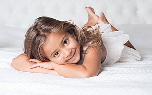 girl lying on bed smiling