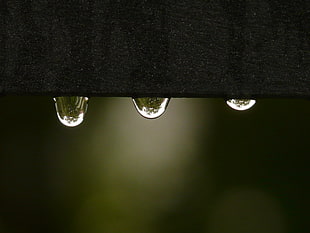 water droplets under black metal part