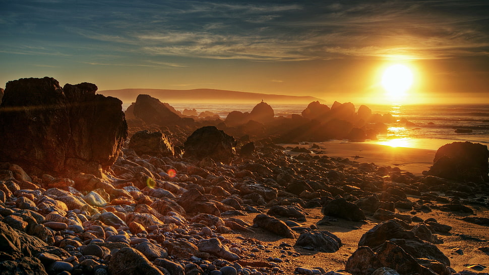 stony seashore during daytime HD wallpaper