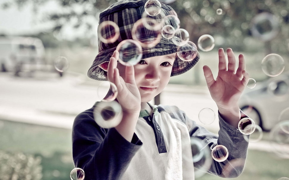 selective focus photography of girl catching bubbles during daytime HD wallpaper