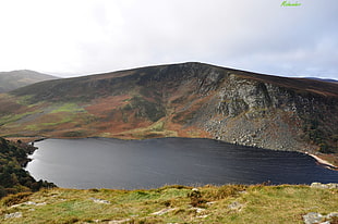 aerial photography of green mountain with lake, wicklow mountains