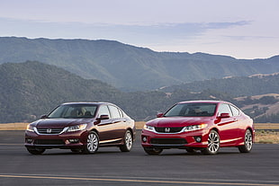 two red and burgundy Honda cars during daytime