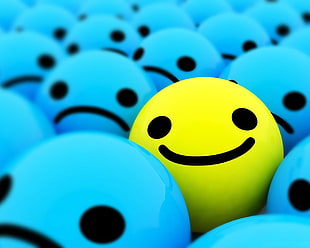 yellow smiling emoji surrounded by blue sad emojis