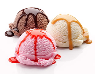 scoop of vanilla, chocolate, and pink ice cream on white sirface