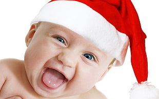 baby wearing red and white santa hat