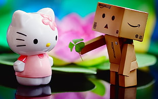 Amazon daboard giving flowers to Hello Kitty figurine photo