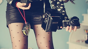 several assorted-type cameras, camera, legs, shorts, stockings