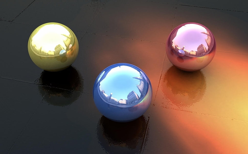 three assorted color marble toys on brown surface HD wallpaper