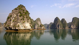 rock monument on calm body of water during daytime