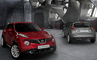 one silver and one red Nissan Juke HD wallpaper