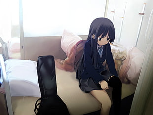 black haired female anime character sitting on bed