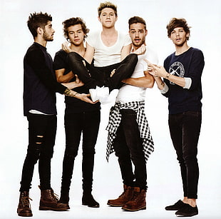 five-person group posing with white background