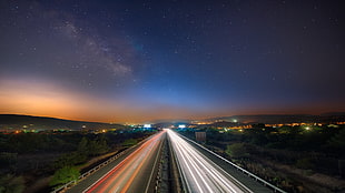 time-lapse photo of road under clear sky