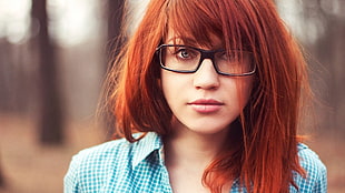 Red haired woman wearing black framed eyeglasses