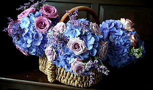 brown wicker basket and blue multi-petaled flowers