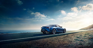 blue sports coupe on concrete road near sea at daytime HD wallpaper